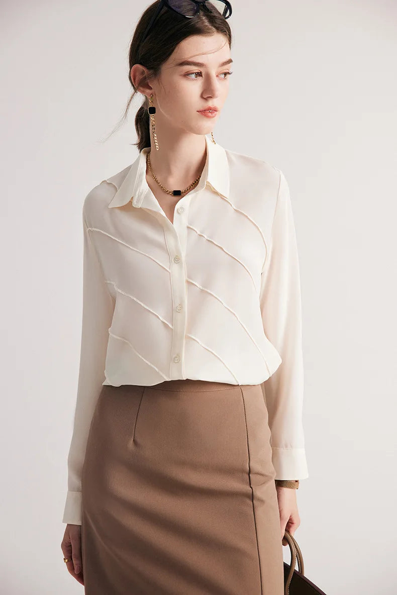 Model looking to the side in silk shirt in Ecru White. From Borcelleclothes.