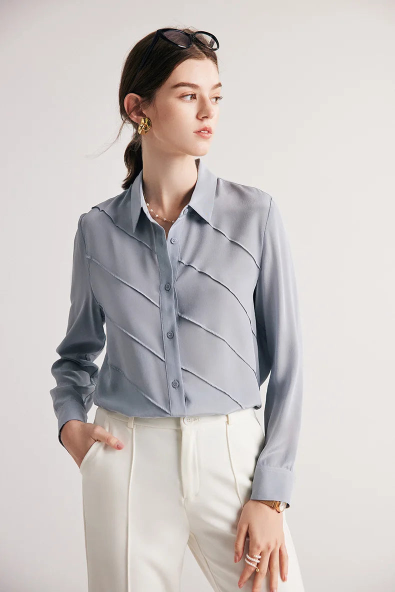 Model with one hand in pants pocket wearing Lavender Grey silk shirt. From Borcelleclothes.