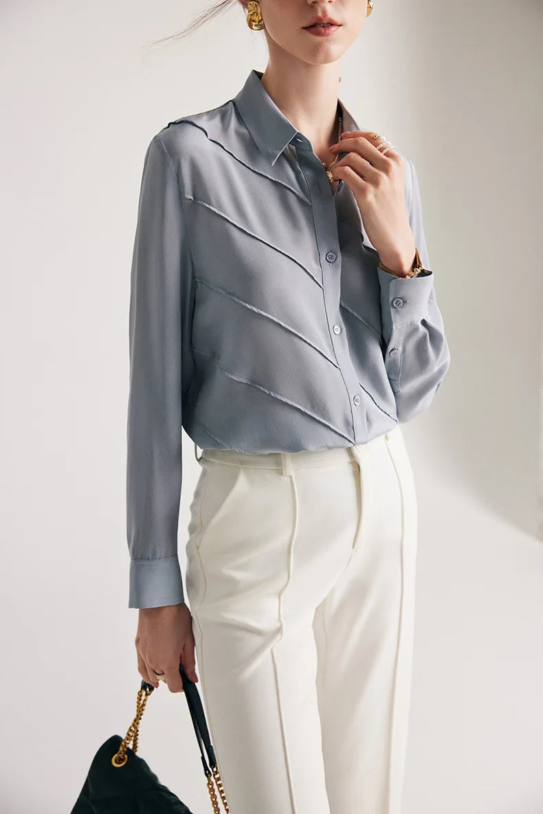 Model touching collar with one hand in Lavender Grey silk shirt. From Borcelleclothes.