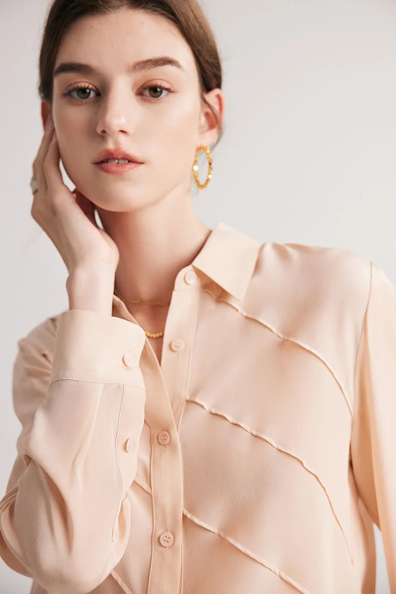 Model touching face while wearing Misty Rose silk shirt, upper part visible. From Borcelleclothes.