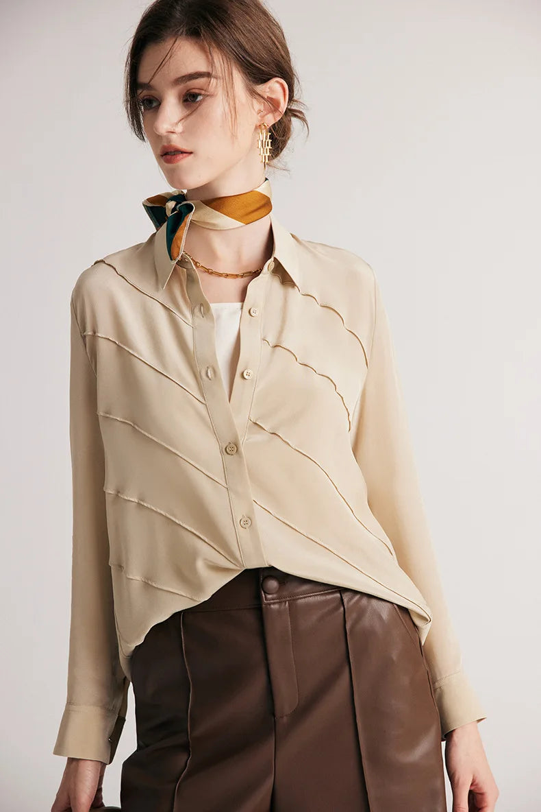 Model looking to the side in silk shirt in Soft Amber. From Borcelleclothes.