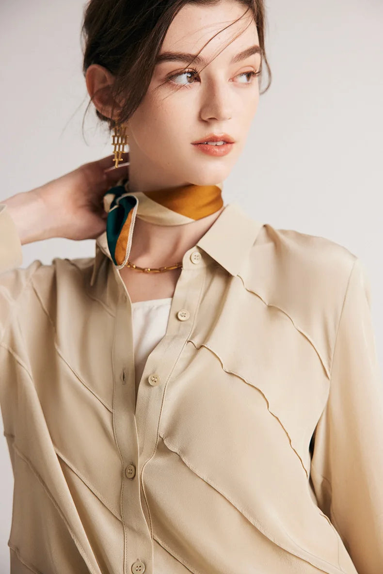 Model touching neck from behind while wearing Soft Amber silk shirt. From Borcelleclothes.