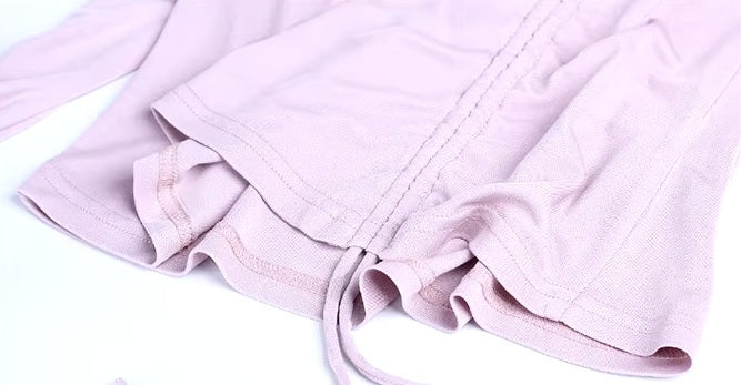 Detailed stitching and textured fabric on the bottom of a Women's Silk Top with Casing in Amour, featuring a high straight neckline and adjustable side tie in luxurious Mulberry Silk Blend. From Borcelleclothes.