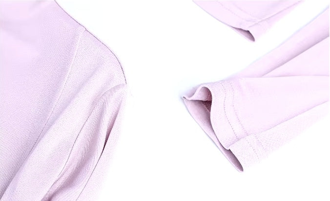 Detailed stitching and textured fabric on the shoulder and sleeve's end of a Women's Silk Top with Casing in Amour, featuring a high straight neckline and adjustable side tie in luxurious Mulberry Silk Blend. From Borcelleclothes.