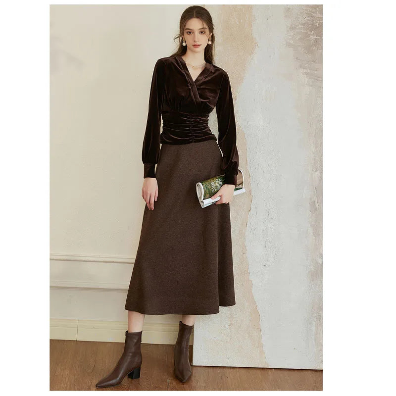 Model in Coffee Bean Silk Velvet Blouse with sculpted waist, holding a journal, showcasing refined style and luxurious texture. From Borcelleclothes.