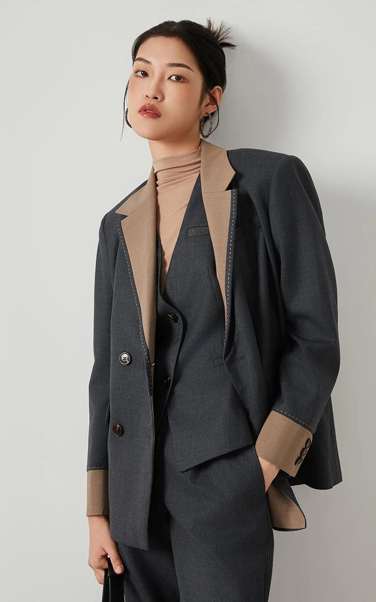 Model wearing women’s Silver Pink & Davy Grey blazer in Davy Grey, hand in pants pocket — From Borcelleclothes.