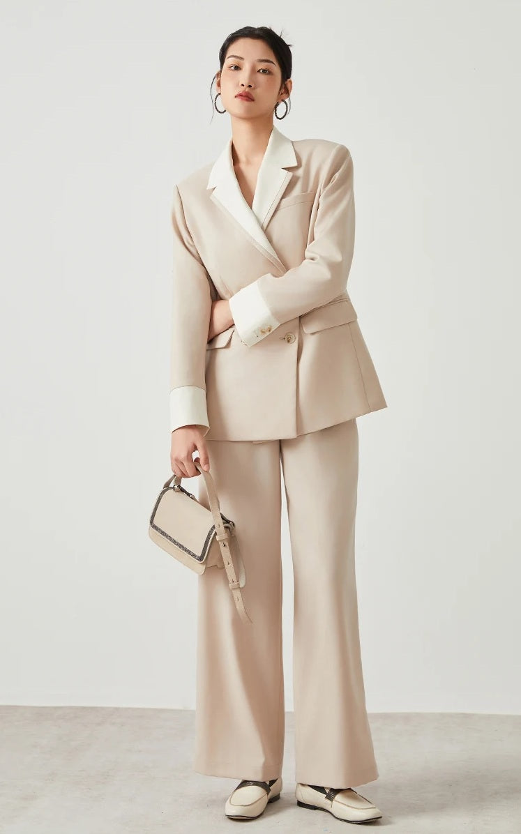 Model wearing women’s Silver Pink & Davy Grey blazer in Silver Pink, holding a tonal bag — From Borcelleclothes.