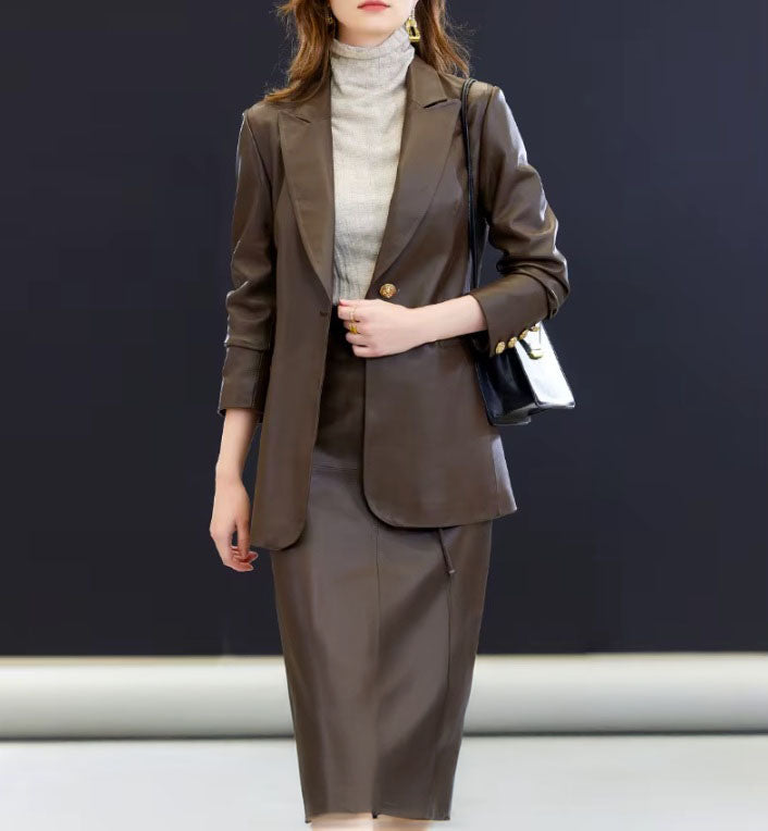 Model in Dark Rum leather blazer unbuttoned, lightly holding one front panel — a gesture that reveals softness behind the silhouette. From Borcelleclothes.