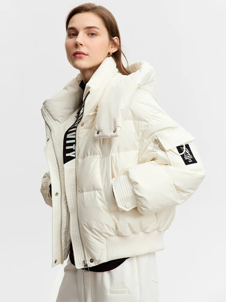 Women's sleek down jacket in Alabaster with wrap collar, detachable hood, and utility sleeve pocket featuring creative detail. From Borcelleclothes.