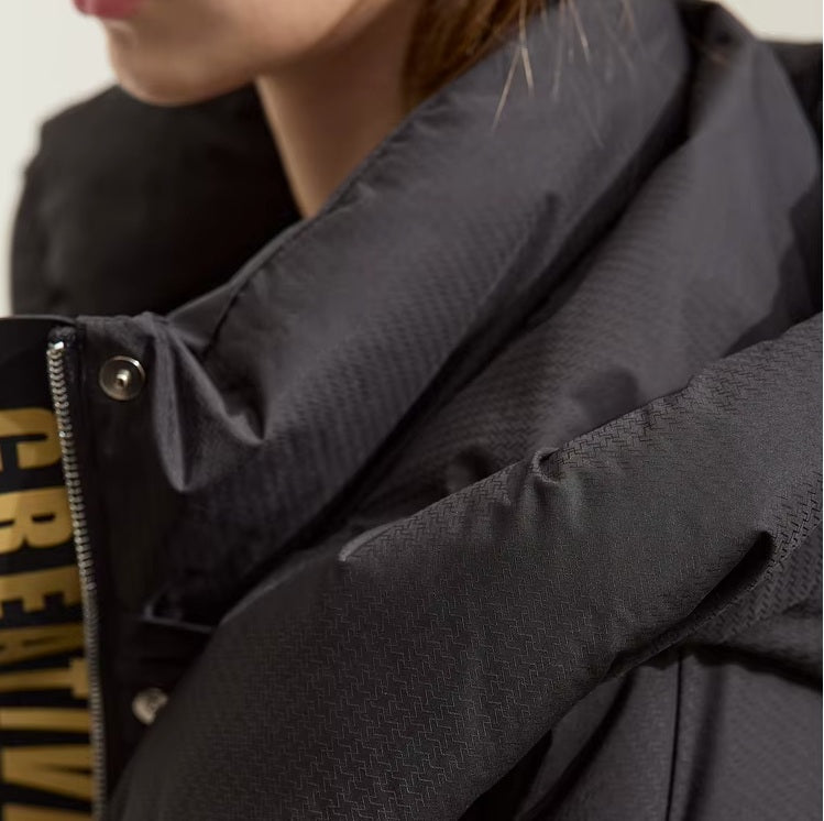 Upper side view of the Onyx sleek down jacket with creative detail. From Borcelleclothes.