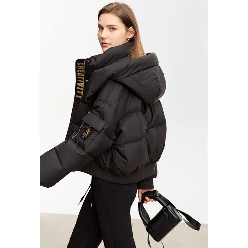 Model walking in the Onyx sleek down jacket, side view. From Borcelleclothes.