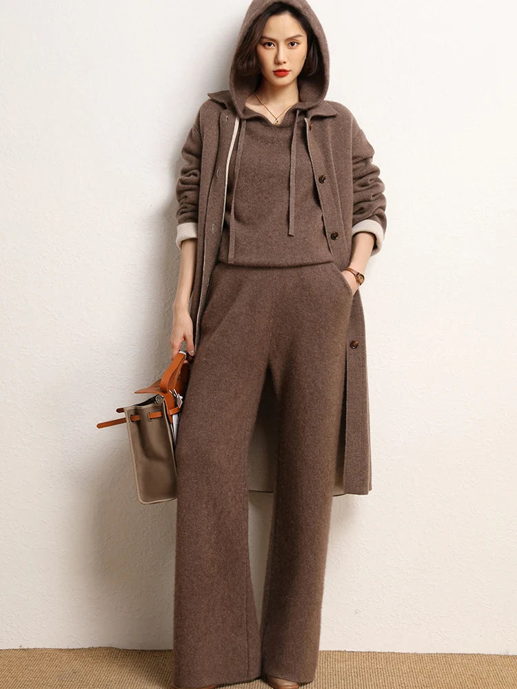 Model holding a bag while wearing Irish Coffee straight-cut cashmere trousers — From Borcelleclothes.