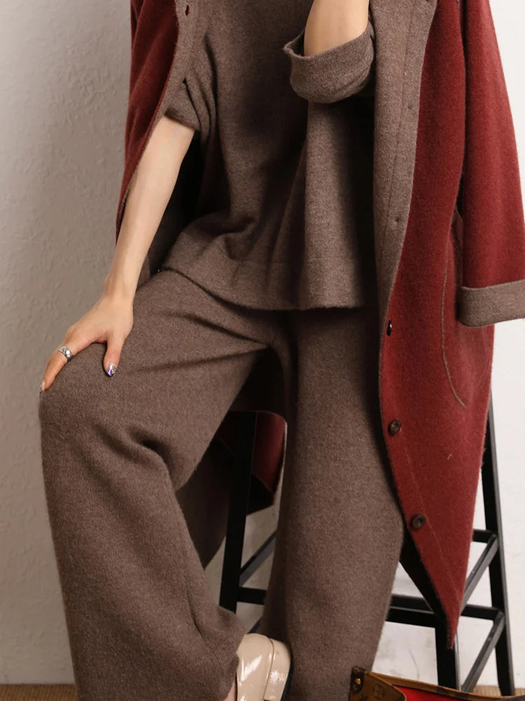 Model sitting on chair in Irish Coffee cashmere trousers — From Borcelleclothes.