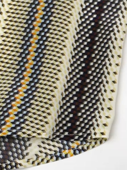 Detailed stitching and textured fabric on the bottom of a striped 3D geometric silk shirt with orange, deep blue, and soft yellow stripes, featuring a cream collar and matching cuffs. From Borcelleclothes.