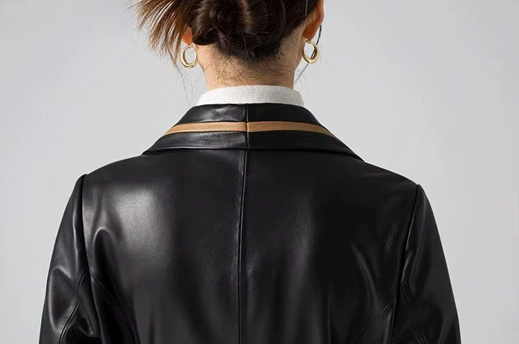 Women's Structured Leather Coat in Onyx with Warm Ochre Trim. Close-up of the back upper section, highlighting contrast-trim detailing and impeccable craftsmanship. Borcelleclothes.