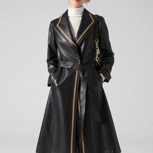 Women's Structured Leather Coat in Onyx with Warm Ochre Trim. Model places hands in discreet welt pockets, highlighting seamless design and tailored precision. Borcelleclothes.