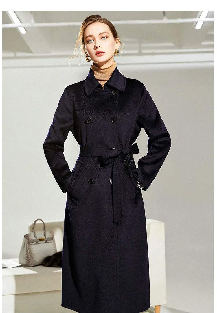 Model in Mirage structured wool coat with hands in pockets, revealing tailored lines. From Borcelleclothes.