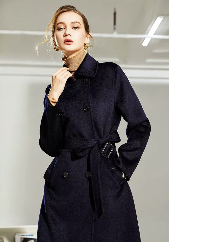 Model touching collar of the Mirage structured wool coat, highlighting pointed collar and silhouette. From Borcelleclothes.