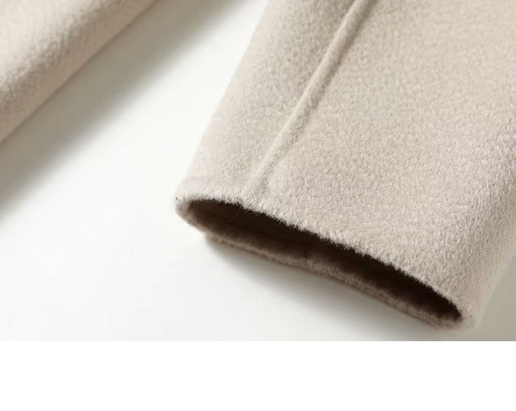 Sleeve cuff of the Pearl Bush structured wool coat with decorative buttons. From Borcelleclothes.