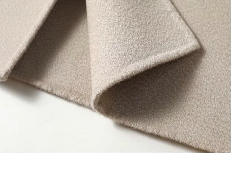 Unfolded bottom hem of the Pearl Bush structured wool coat, revealing structure and finish. From Borcelleclothes.