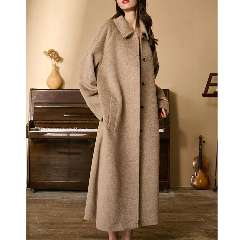 Model in Pale Taupe coat with head turned to the side, highlighting the coat’s silhouette. From Borcelleclothes.