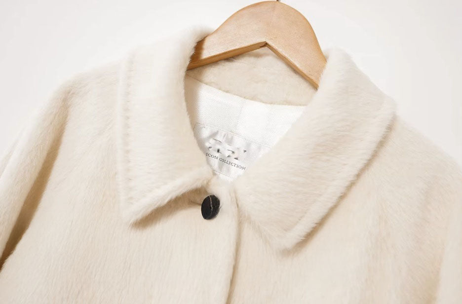 Detailed view of the pointed collar of the Pearl Bush Suri alpaca wool coat. From Borcelleclothes.