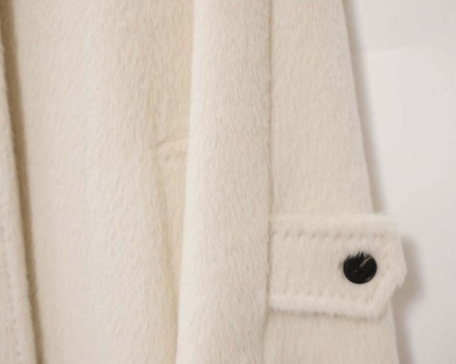 Raglan sleeve of the Pearl Bush coat featuring a decorative tab and button. From Borcelleclothes.