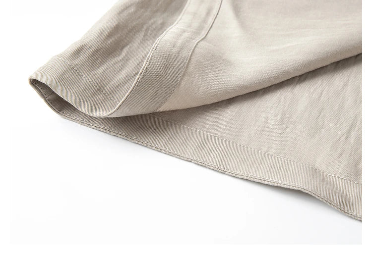 Dress hem shown unfolded — fluid A-line drape in soft Swiss Coffee fabric. From Borcelleclothes.