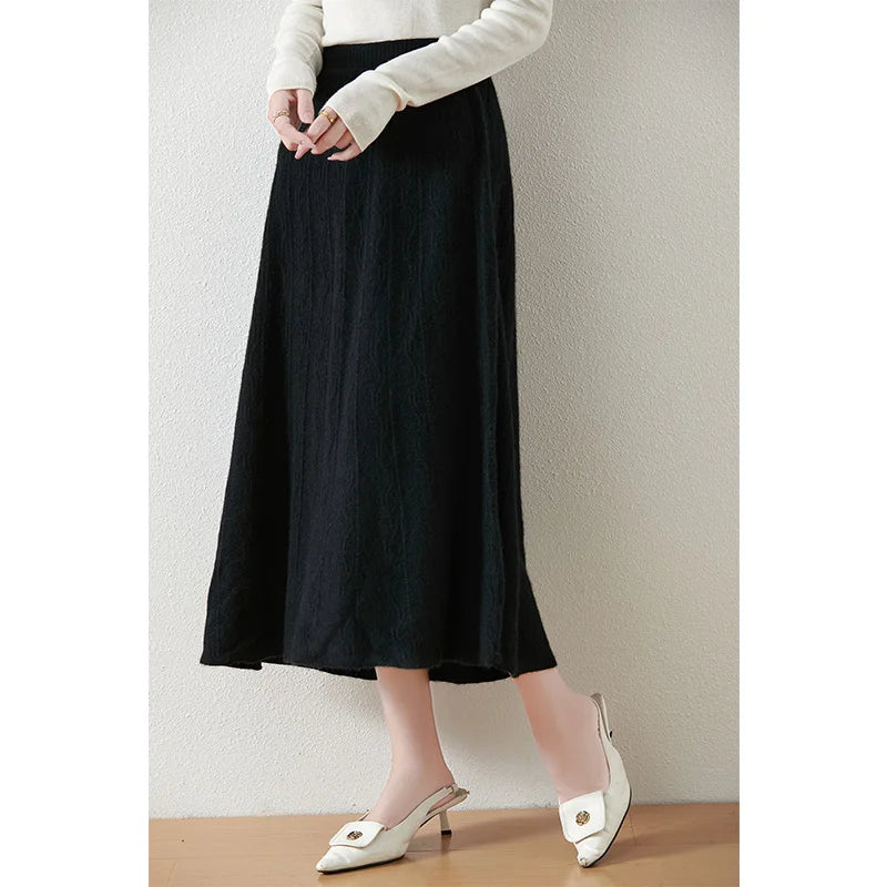 Onyx textured merino skirt, model turned slightly to the side, showing deep tone, structure, and quiet movement — From Borcelleclothes.