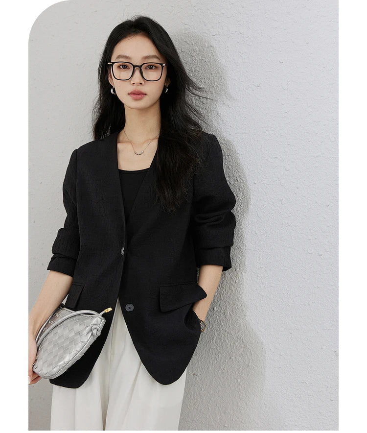 Model with hand in pants pocket wearing an Onyx textured pinstripe crinkle blazer. From Borcelleclothes.