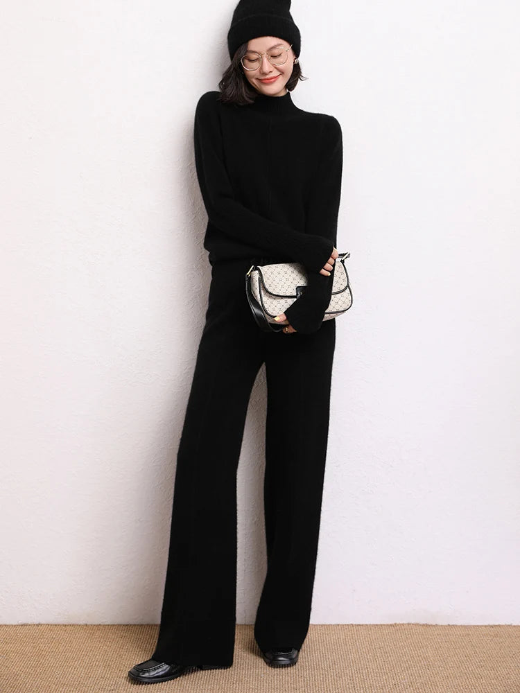 Model wearing Traced Seaming Cashmere Trousers in Onyx, holding a bag — From Borcelleclothes.