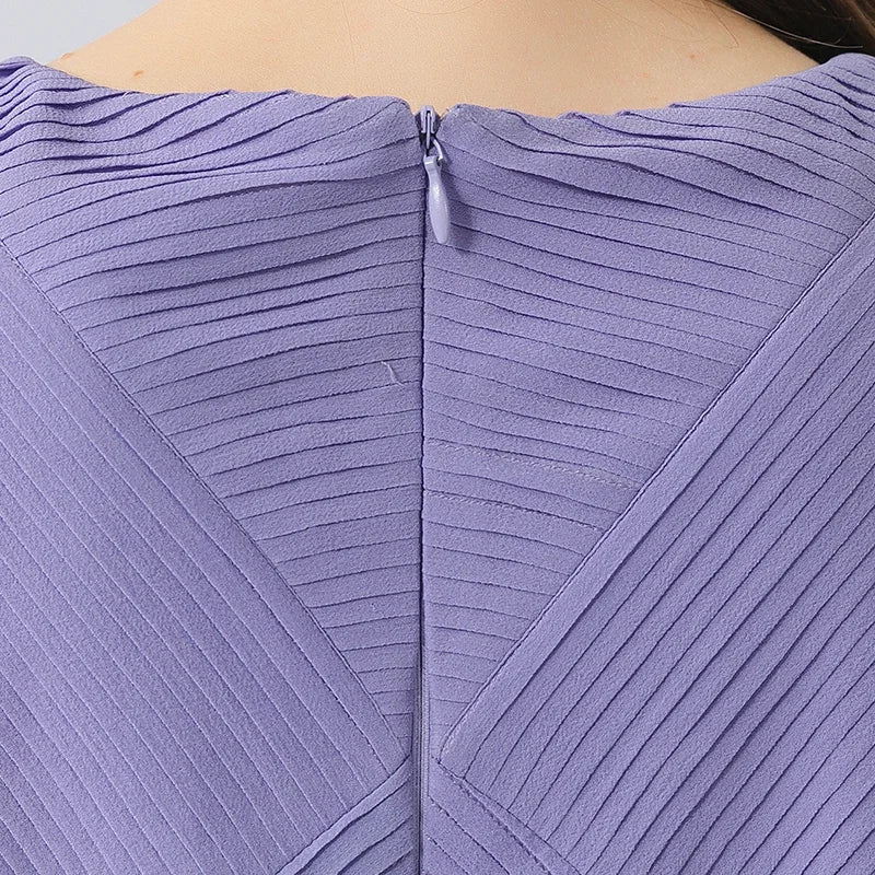 Back view of the upper part, showing the invisible zipper and the sculptural lines created by the tuck arrangement. From Borcelleclothes.