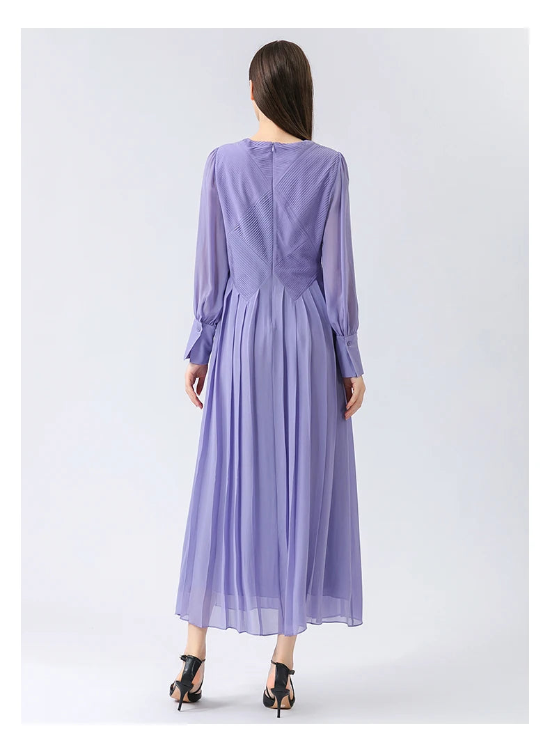 Rear view of the dress, revealing the clean fall of pleats and how the silhouette flows quietly away from the body. From Borcelleclothes.