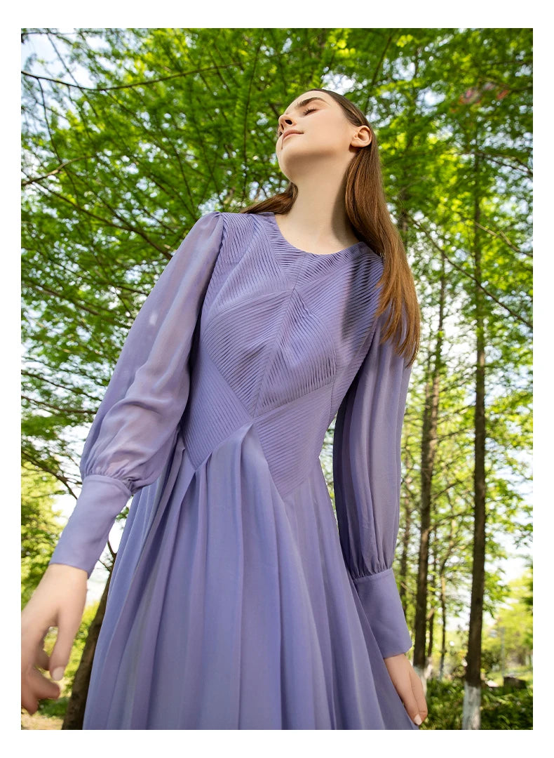 Model with closed eyes standing still in a forest setting, the soft pleats and structured top capturing a moment of stillness. From Borcelleclothes.