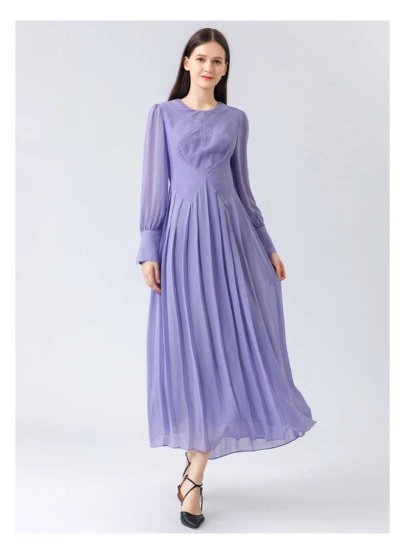 Model stepping forward, the calf-length pleats shifting slightly in motion, catching air around the hem. From Borcelleclothes.