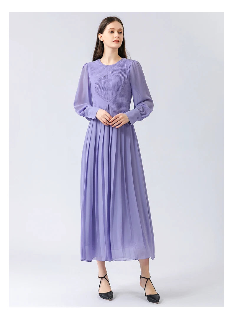 Model gently touching her fingertips, highlighting the dress’s balance between composed structure and quiet gesture. From Borcelleclothes.