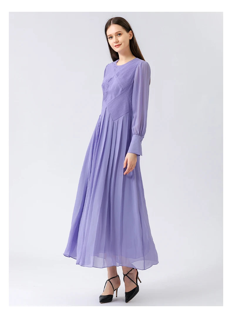 Model turned at a slight angle, the play of alternating tucks visible across the bodice under soft natural light. From Borcelleclothes.