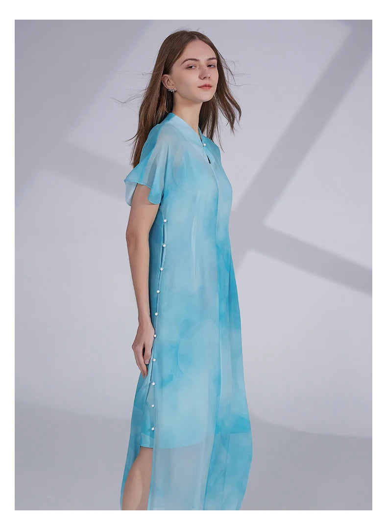 Model turned slightly to the side, revealing the flow and soft volume of the two-piece Glacier silk ensemble. From Borcelleclothes.