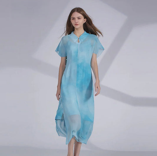 Two-piece women’s Mulberry silk ensemble in Glacier color, featuring a straight-cut camisole and a sheer chiffon outer layer with a high collar and side button closure. From Borcelleclothes.