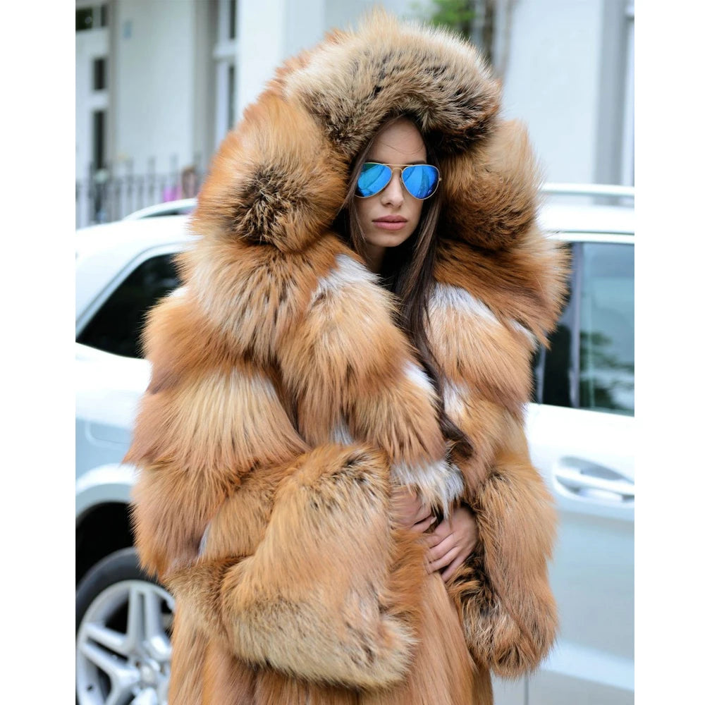 The upper part of a whiskey silver fox fur coat, the model lifted the hood to reveal the rich texture and luxurious volume of the fur. From Borcelleclothes.