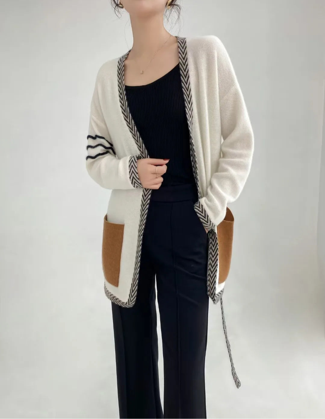 Whispering Smoke cashmere cardigan worn open, model’s hand in pants pocket, highlighting the airy knit and casual styling — From Borcelleclothes.