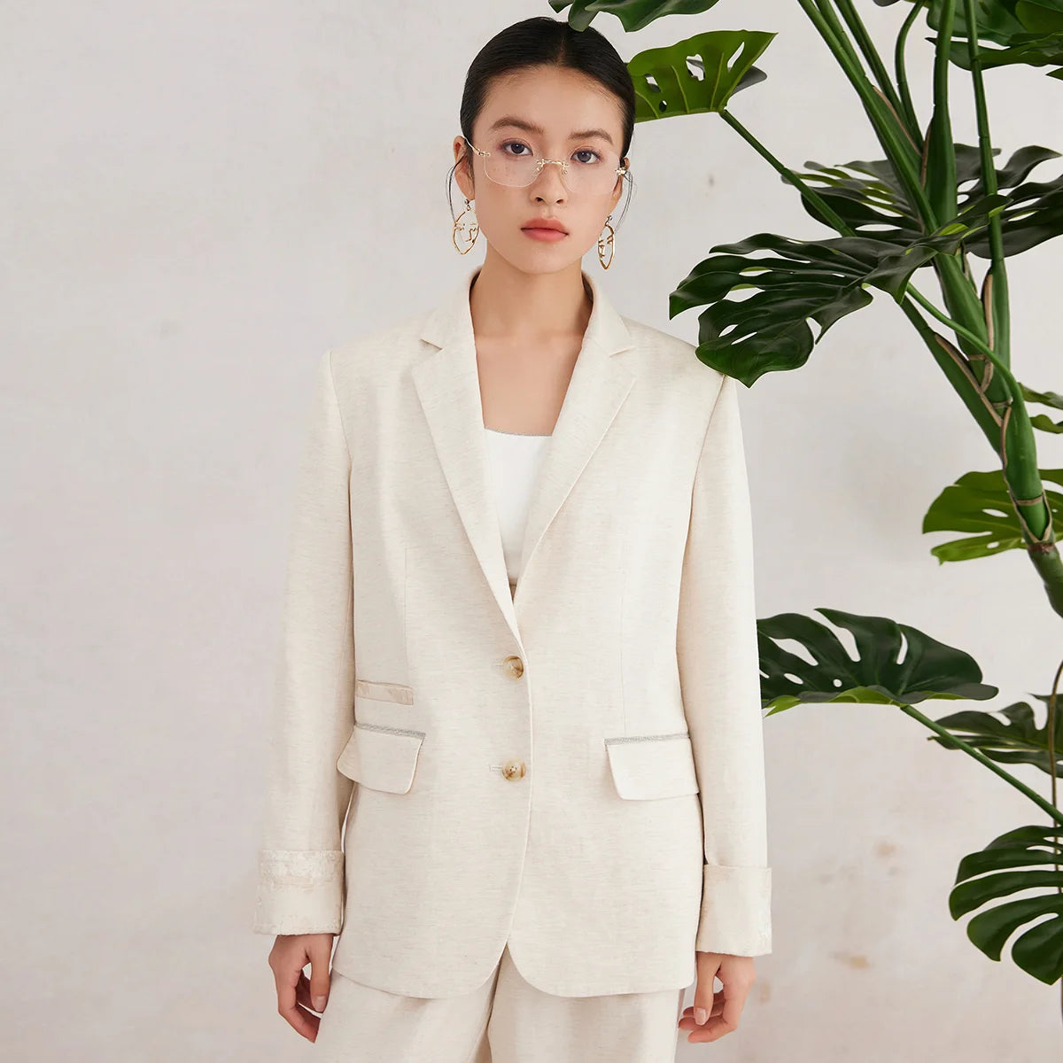 Women’s White Coffee blazer with straight silhouette, jacquard-covered cuffs, and asymmetrical pocket detail — a textured design shaped by natural fibers and quiet complexity. From Borcelleclothes.