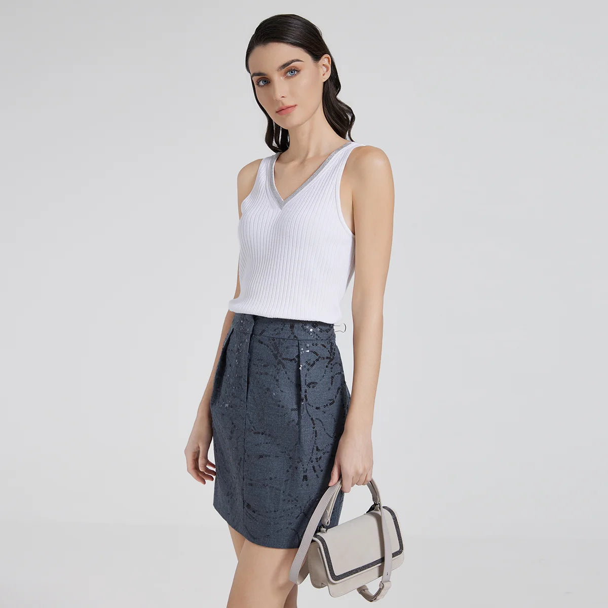 Model wearing White Lilac wide-rib V-neckline top with one knee slightly bent. From Borcelleclothes.