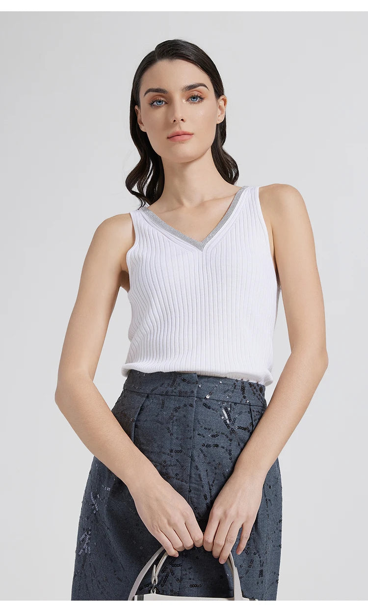 Model in White Lilac wide-rib V-neckline top holding a bag in front. From Borcelleclothes.