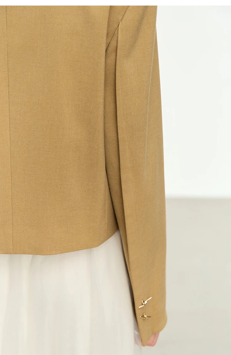 Back view of the Women’s Wire Knot Detail Blazer in French Beige with sleeve dart and cuff buttons. From Borcelleclothes.