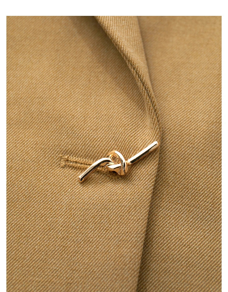 Close-up of the decorative wire knot button on the Women’s Wire Knot Detail Blazer in French Beige. From Borcelleclothes.