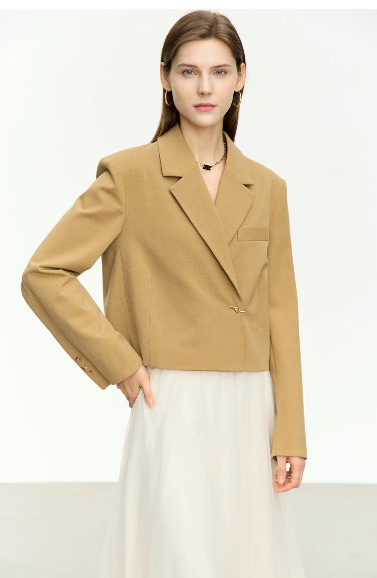 Women’s Wire Knot Detail Blazer in French Beige, model posing with hand on hip. From Borcelleclothes.