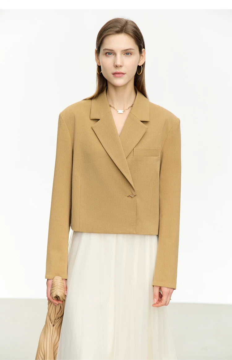 Women’s Wire Knot Detail Blazer in French Beige, model holding a handbag. From Borcelleclothes.