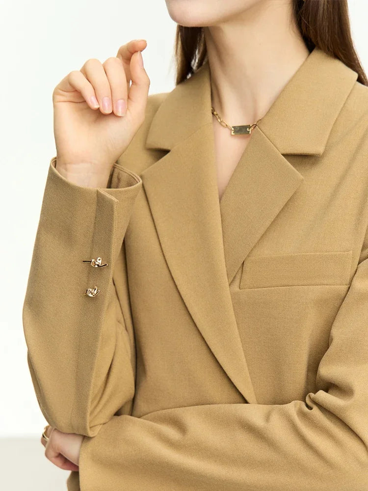 Women’s Wire Knot Detail Blazer in French Beige, model showing back with visible sleeve dart. From Borcelleclothes.