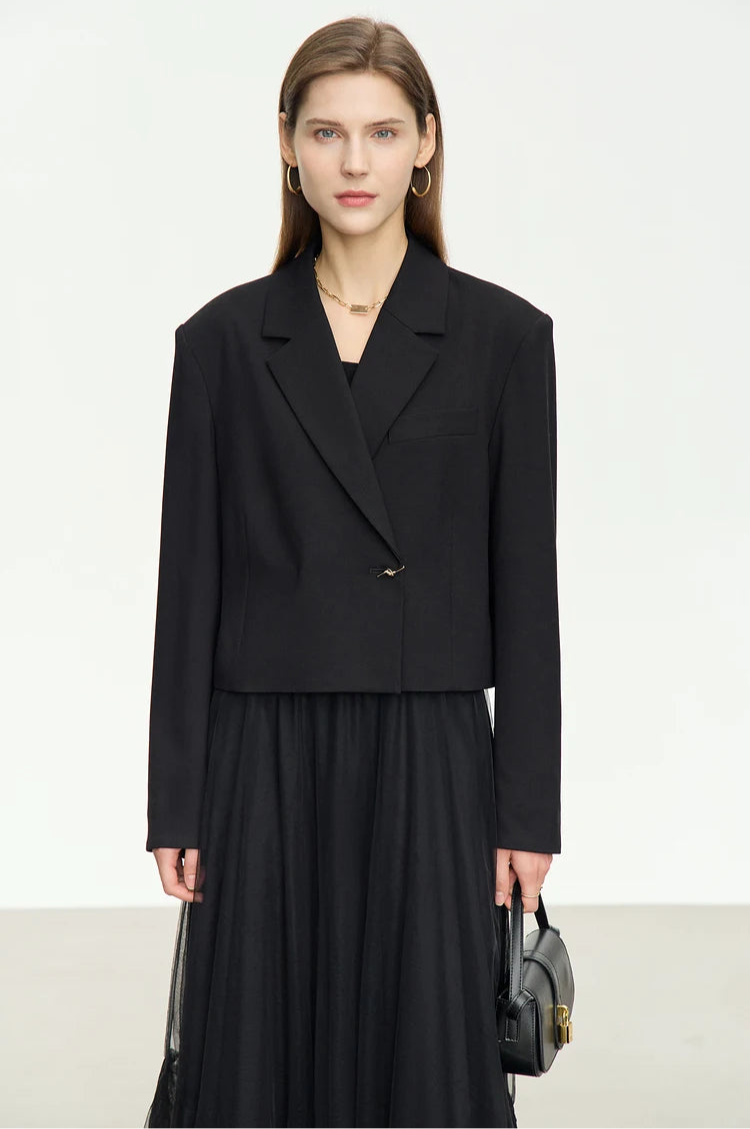 Women’s Wire Knot Detail Blazer in Onyx, model holding a small bag. From Borcelleclothes.